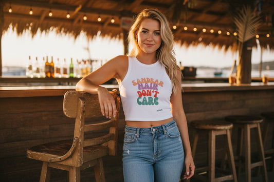 White tank top with colorful text 'SANDBAR HAIR DON'T CARE' on a white background