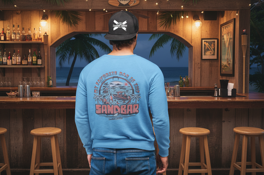 Person wearing a blue sweatshirt with a graphic design and a black cap on a gray background